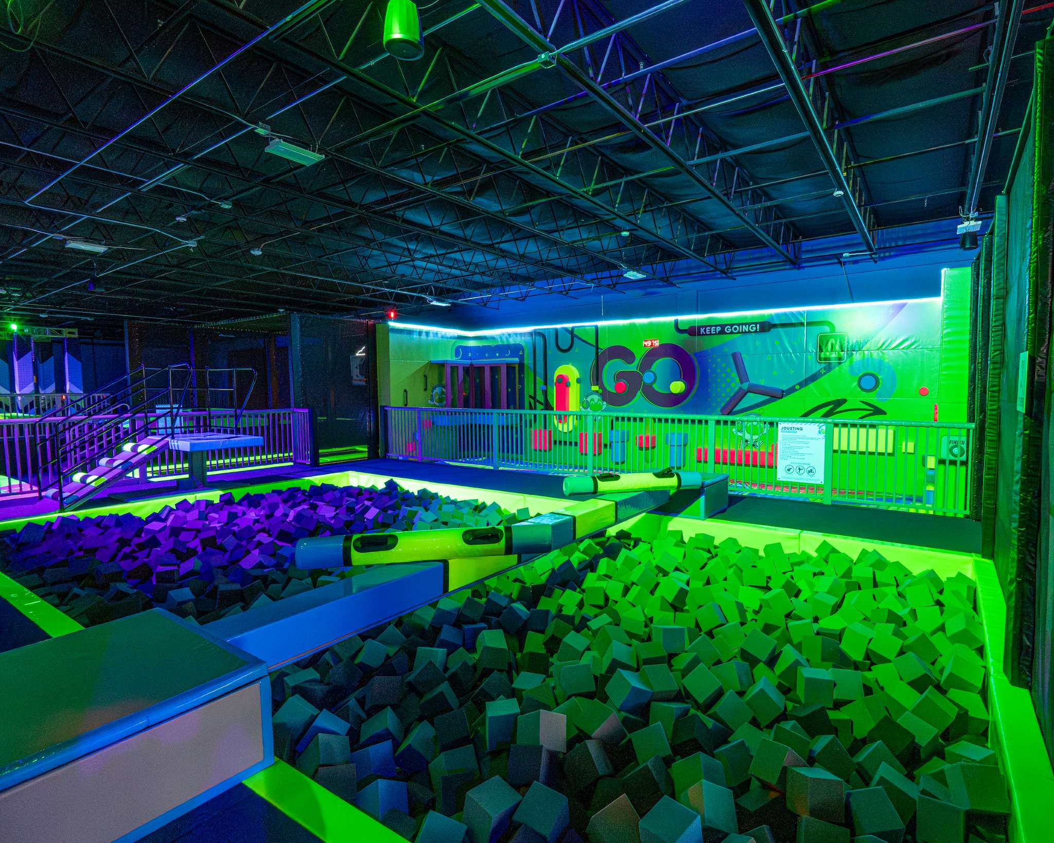 Foam pits glowing green and purple under neon lights at NRG Fargo