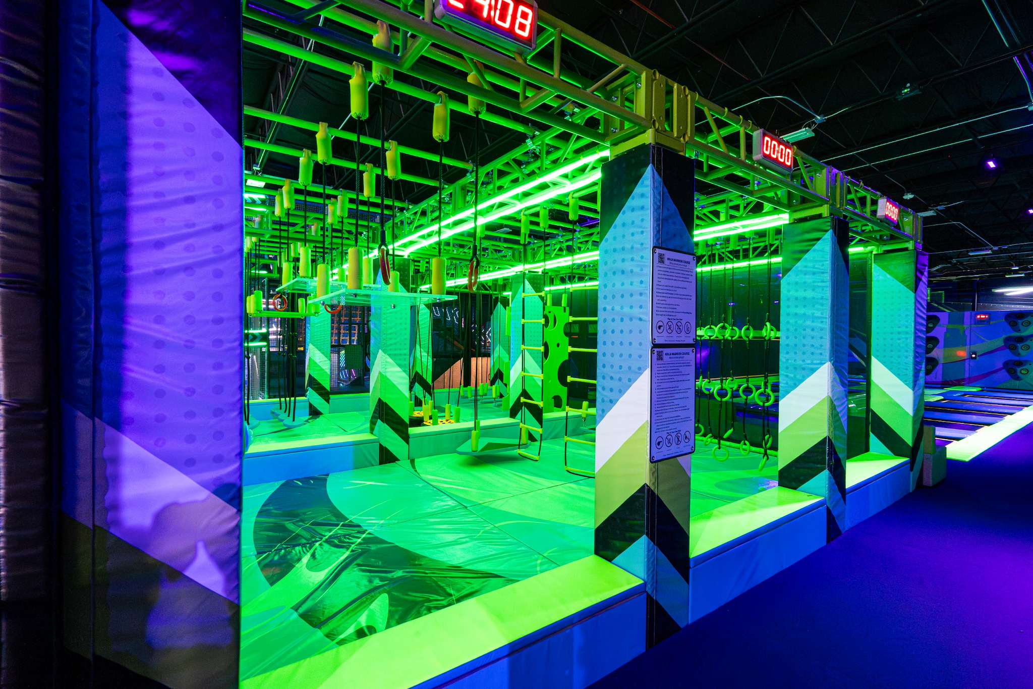 Ninja course lit in neon green at NRG Fargo