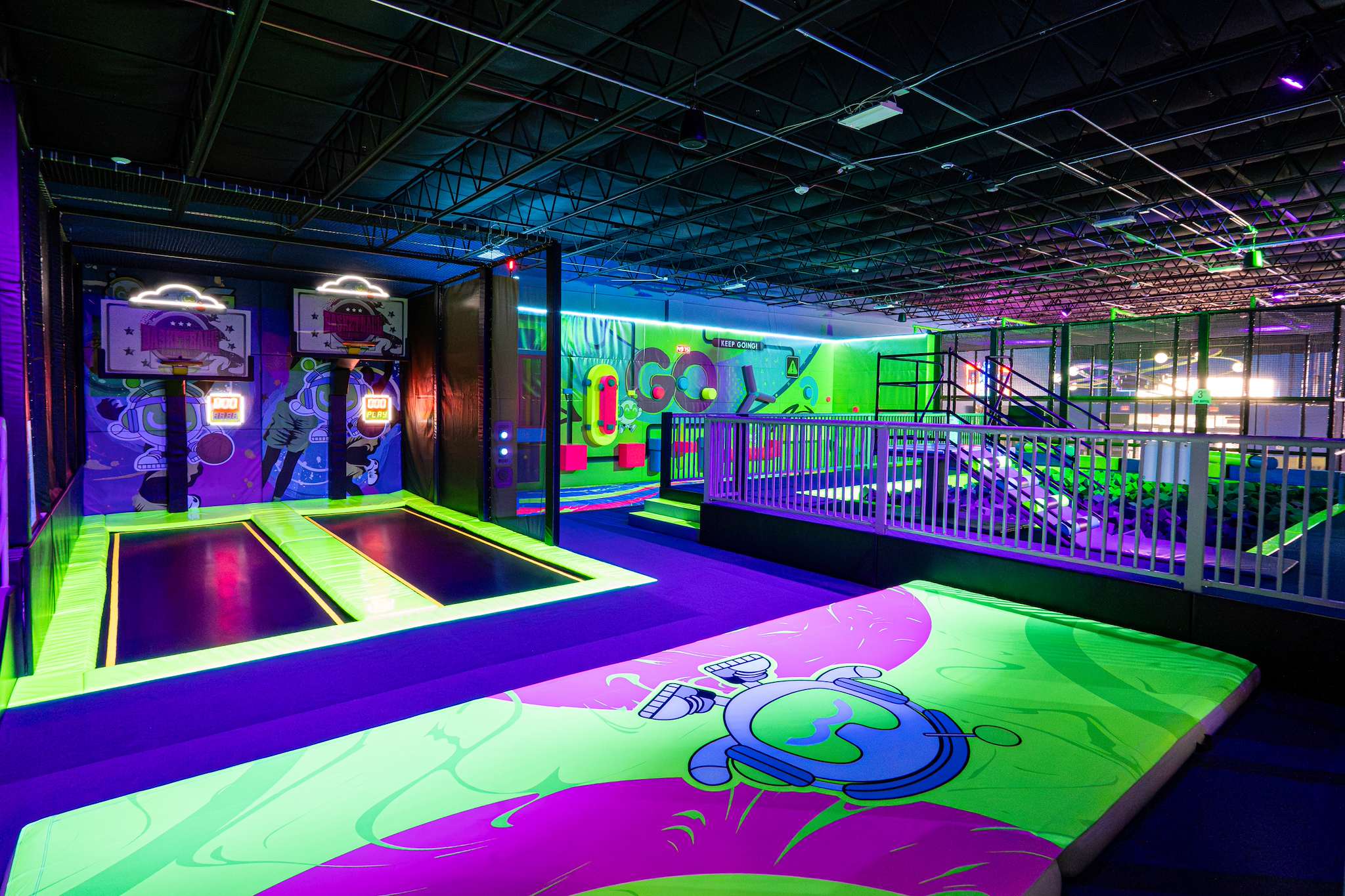 Trampolines and dunk lanes under neon lights at NRG Fargo