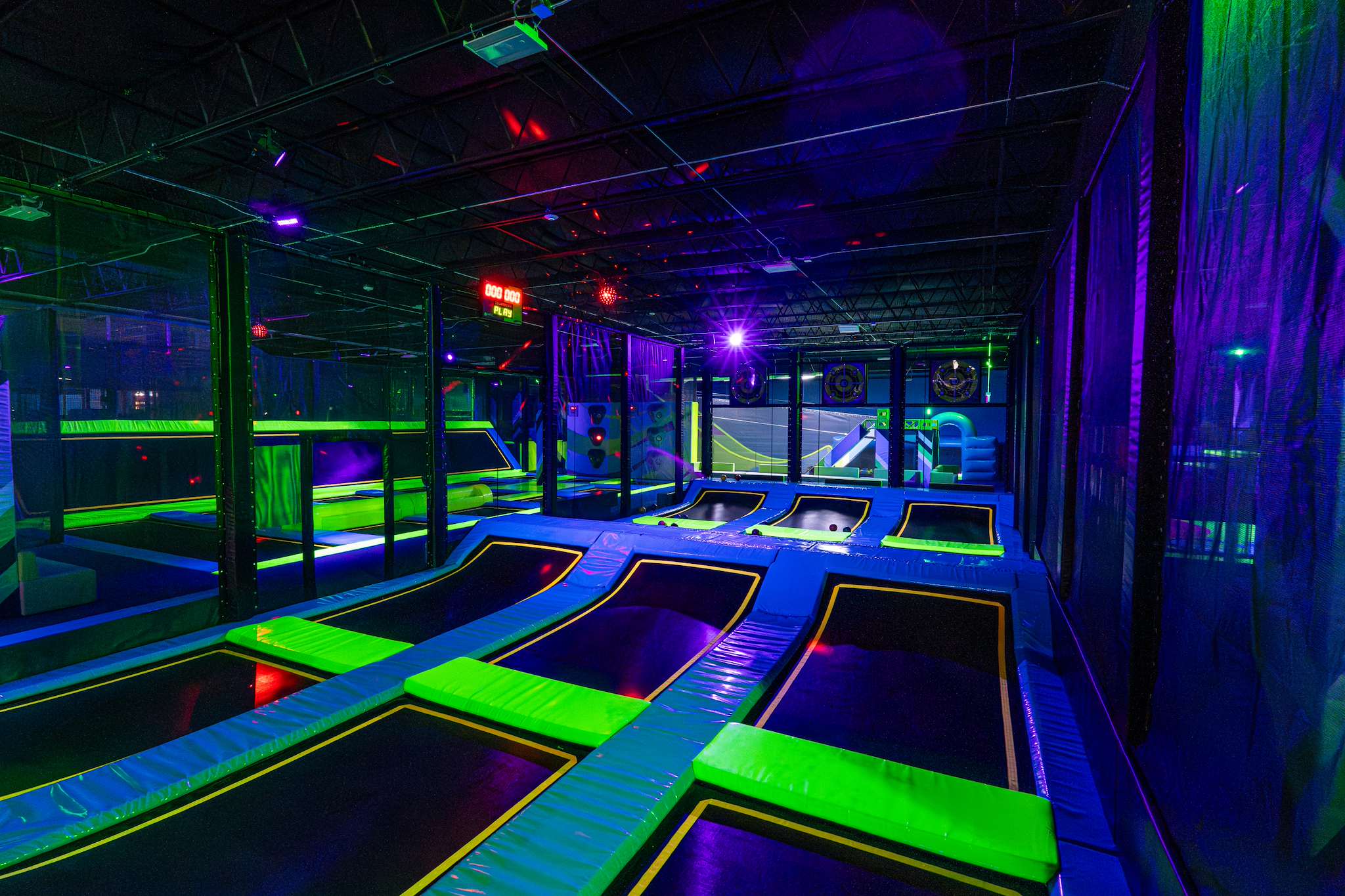 Trampoline lanes glowing green and purple at NRG Fargo