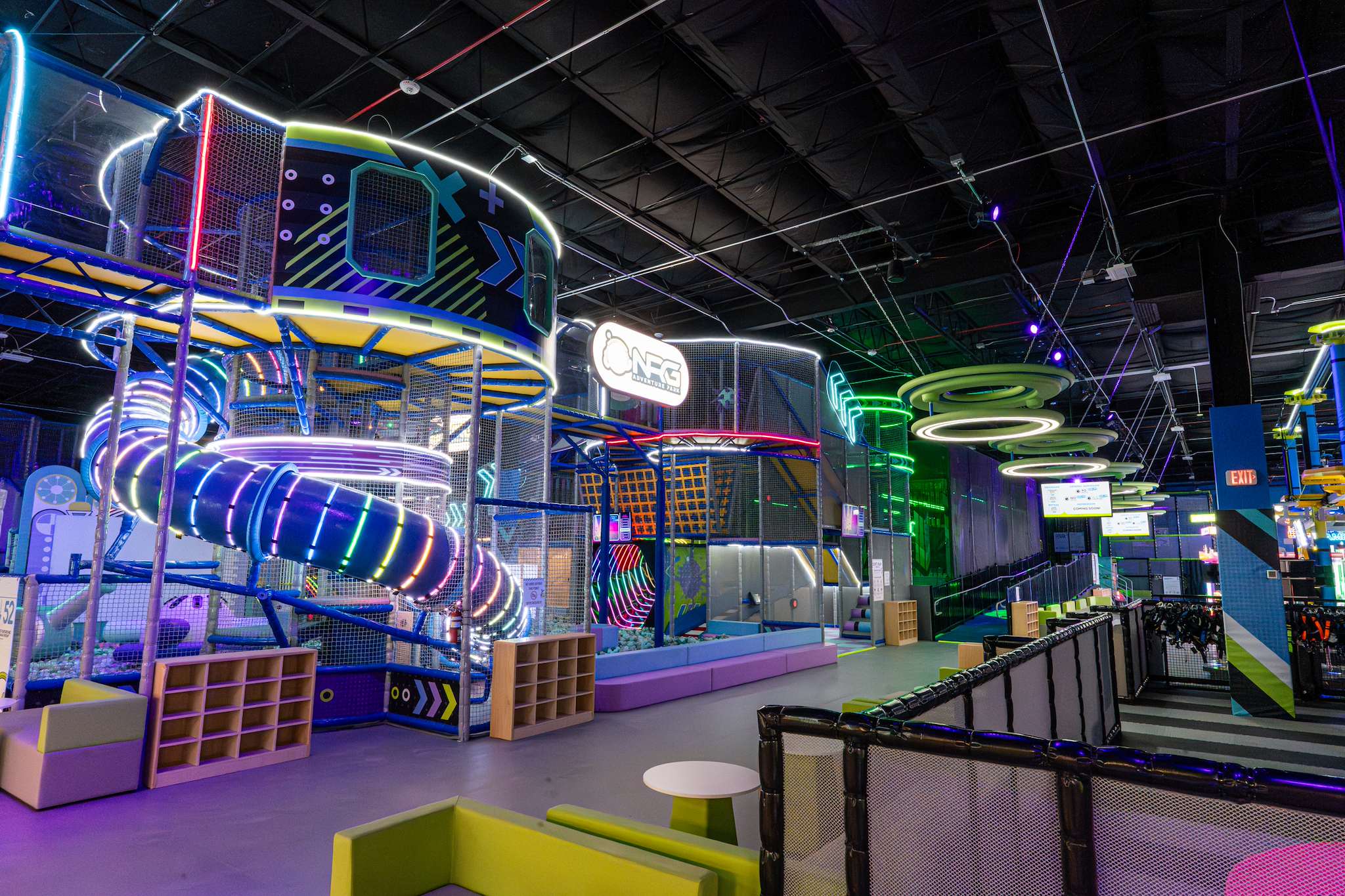 Play structure with neon rings and a spiral slide at NRG Fargo